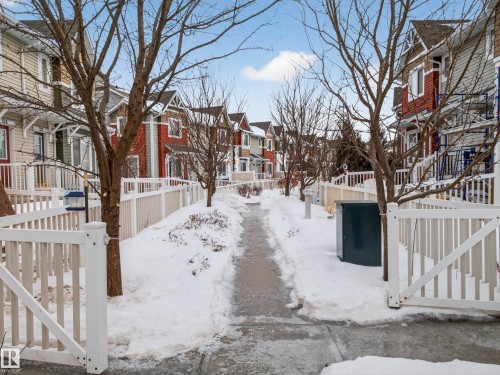 Snowy yard with a residential view - 125 655 Tamarack Road, Edmonton, AB - Outdoor