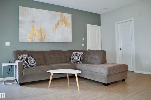 Living room with light wood-type flooring - 437 1818 Rutherford Road, Edmonton, AB - Indoor Photo Showing Living Room