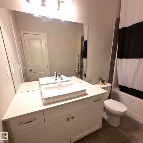 Full bath featuring vanity and shower / tub combo - 437 1818 Rutherford Road, Edmonton, AB - Indoor Photo Showing Bathroom