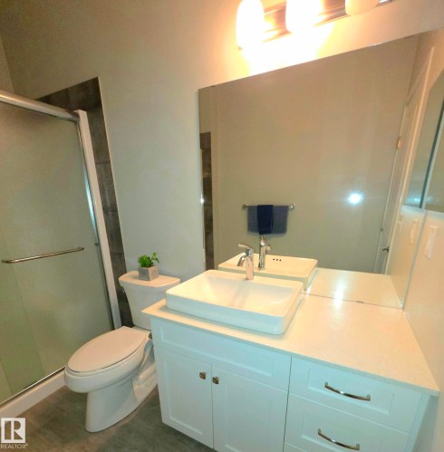 Full bath with vanity and a shower stall - 437 1818 Rutherford Road, Edmonton, AB - Indoor Photo Showing Bathroom
