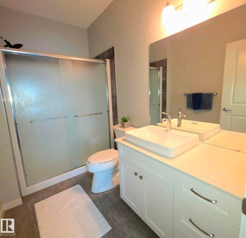 Full bath with a shower stall and vanity - 437 1818 Rutherford Road, Edmonton, AB - Indoor Photo Showing Bathroom