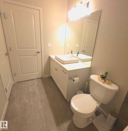 Half bathroom with vanity and toilet - 437 1818 Rutherford Road, Edmonton, AB - Indoor Photo Showing Bathroom