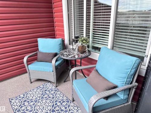 Covered patio with red horizontal siding - 437 1818 Rutherford Road, Edmonton, AB - Outdoor With Exterior