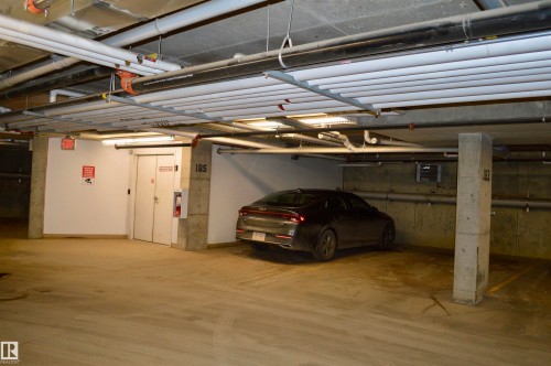 Garage with a parking deck and a heating unit - 437 1818 Rutherford Road, Edmonton, AB - Indoor Photo Showing Garage