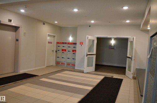 Building lobby with recessed lighting - 437 1818 Rutherford Road, Edmonton, AB - Indoor Photo Showing Other Room
