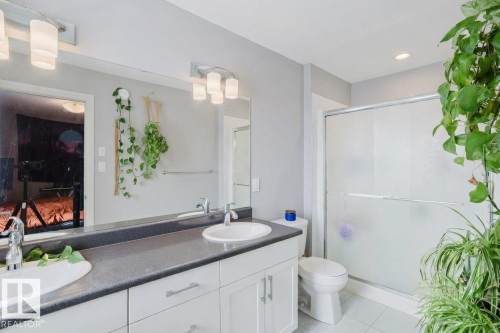 Bathroom featuring double vanity, a stall shower, and light tile patterned floors - 326 West Haven Drive, Leduc, AB - Indoor Photo Showing Bathroom