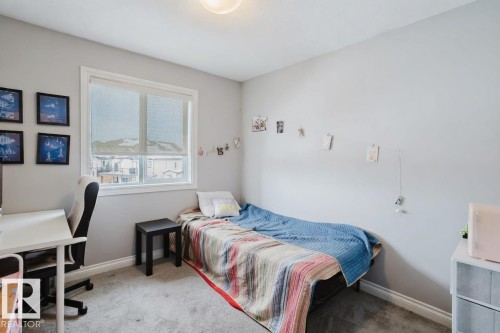 Bedroom featuring light carpet and a desk - 326 West Haven Drive, Leduc, AB - Indoor Photo Showing Bedroom