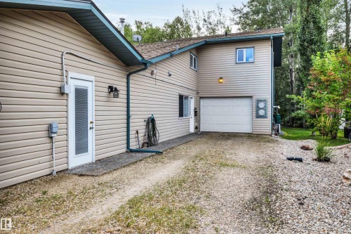 Back of property with dirt driveway and a garage - 605 6St. Ross Haven, Rural Lac Ste. Anne County, AB - Outdoor With Exterior