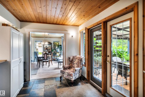 Entryway with wood ceiling, stone tile floors, and hanging lights - 605 6St. Ross Haven, Rural Lac Ste. Anne County, AB - Indoor Photo Showing Other Room