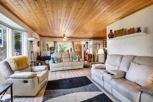 Living area with wooden ceiling, wood finished floors, and a ceiling fan - 605 6St. Ross Haven, Rural Lac Ste. Anne County, AB - Indoor Photo Showing Living Room