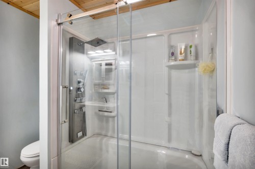 Bathroom featuring a stall shower and wood ceiling - 605 6St. Ross Haven, Rural Lac Ste. Anne County, AB - Indoor Photo Showing Bathroom