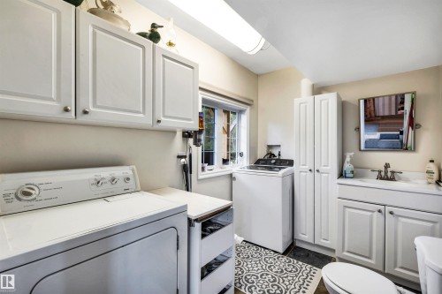 Laundry room with separate washer and dryer and a skylight - 605 6St. Ross Haven, Rural Lac Ste. Anne County, AB - Indoor Photo Showing Laundry Room