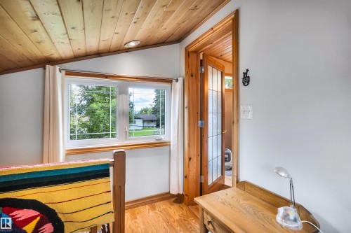 Bedroom with light wood finished floors and a vaulted wooden ceiling - 605 6St. Ross Haven, Rural Lac Ste. Anne County, AB - Indoor