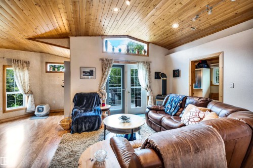 Living room with a vaulted wood ceiling, french doors, and wood finished floors - 605 6St. Ross Haven, Rural Lac Ste. Anne County, AB - Indoor Photo Showing Living Room