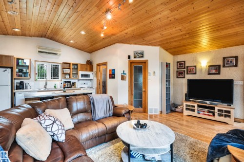 Living area featuring a vaulted wooden ceiling, light wood-style flooring, and recessed lighting - 605 6St. Ross Haven, Rural Lac Ste. Anne County, AB - Indoor Photo Showing Living Room