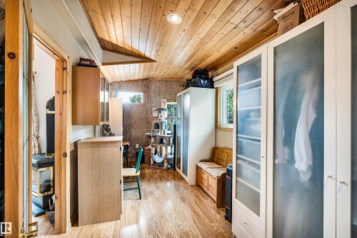 Kitchen with wooden ceiling, healthy amount of natural light, light wood-style flooring, light countertops, and wood finish cabinets - 605 6St. Ross Haven, Rural Lac Ste. Anne County, AB - Indoor Photo Showing Other Room