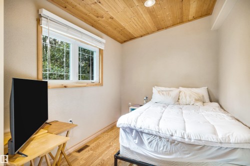Bedroom featuring wood finished floors and a vaulted wood ceiling - 605 6St. Ross Haven, Rural Lac Ste. Anne County, AB - Indoor Photo Showing Bedroom