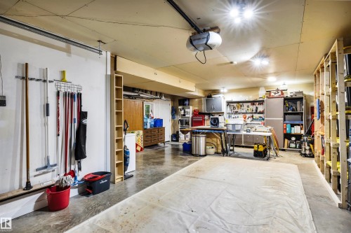 Garage with a workshop area and a garage door opener - 605 6St. Ross Haven, Rural Lac Ste. Anne County, AB - Indoor Photo Showing Garage