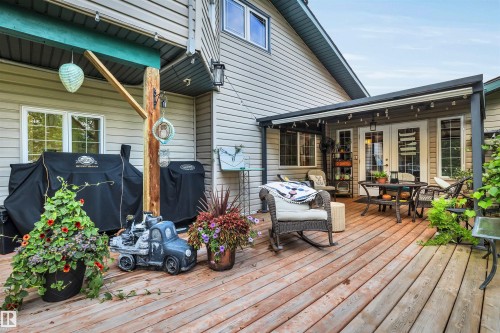 Deck featuring outdoor dining space, french doors, and area for grilling - 605 6St. Ross Haven, Rural Lac Ste. Anne County, AB - Outdoor With Deck Patio Veranda With Exterior