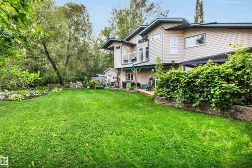 Back of house with a yard and view of wooded area - 605 6St. Ross Haven, Rural Lac Ste. Anne County, AB - Outdoor