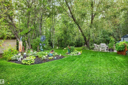 View of grassy yard with an outdoor structure - 605 6St. Ross Haven, Rural Lac Ste. Anne County, AB - Outdoor