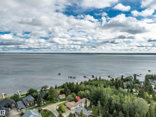 Aerial overview of property's location with a large body of water and nearby suburban area - 605 6St. Ross Haven, Rural Lac Ste. Anne County, AB - Outdoor With Body Of Water With View