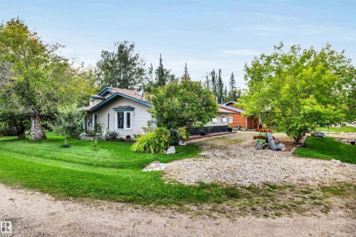 View of property exterior featuring a yard - 605 6St. Ross Haven, Rural Lac Ste. Anne County, AB - Outdoor