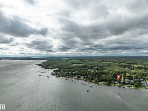 Drone / aerial view of a nearby body of water and a heavily wooded area - 605 6St. Ross Haven, Rural Lac Ste. Anne County, AB - Outdoor With Body Of Water With View