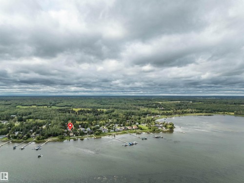 Aerial view of a heavily wooded area and a large body of water - 605 6St. Ross Haven, Rural Lac Ste. Anne County, AB - Outdoor With Body Of Water With View