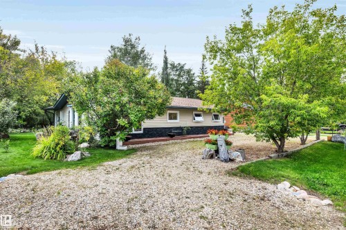 Rear view of property featuring a lawn - 605 6St. Ross Haven, Rural Lac Ste. Anne County, AB - Outdoor