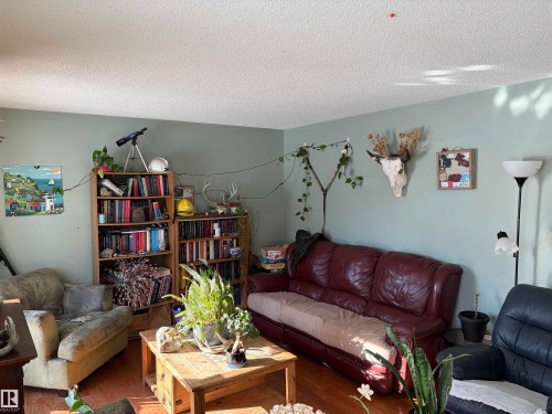 Living room featuring wood finished floors and a textured ceiling - 2008 4Th Ave, Cold Lake, AB - Indoor Photo Showing Living Room