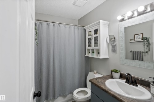 Bathroom with vanity, a textured ceiling, and shower / bath combo - 7 Chungo Drive, Devon, AB - Indoor Photo Showing Bathroom