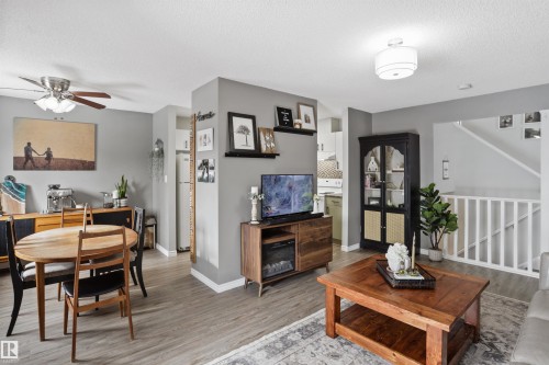 Living area with light wood-style flooring, a ceiling fan, and a textured ceiling - 7 Chungo Drive, Devon, AB - Indoor