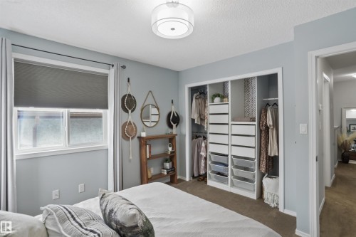 Carpeted bedroom with a closet and a textured ceiling - 7 Chungo Drive, Devon, AB - Indoor Photo Showing Bedroom