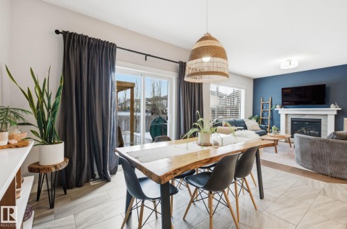 69 Avonlea Way, Spruce Grove, AB - Indoor Photo Showing Dining Room With Fireplace