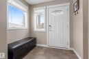 Foyer with healthy amount of natural light and stone finish floors - 523 55101 Ste. Anne Trail, Rural Lac Ste. Anne County, AB  - Indoor Photo Showing Other Room 
