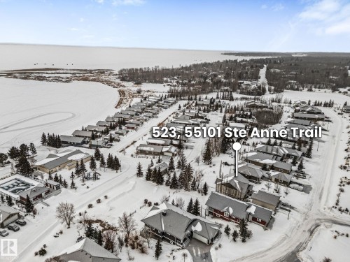 Snowy aerial view with a residential view - 523 55101 Ste. Anne Trail, Rural Lac Ste. Anne County, AB - Outdoor With View