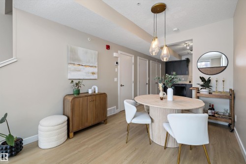 Dining space with light wood-style flooring and a textured ceiling - 94 2560 Pegasus Boulevard, Edmonton, AB - Indoor Photo Showing Dining Room