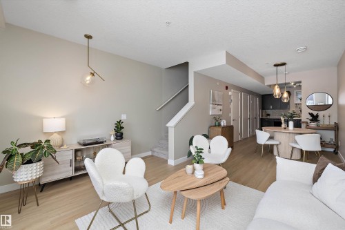 Living room featuring light wood-style floors and a textured ceiling - 94 2560 Pegasus Boulevard, Edmonton, AB - Indoor Photo Showing Living Room
