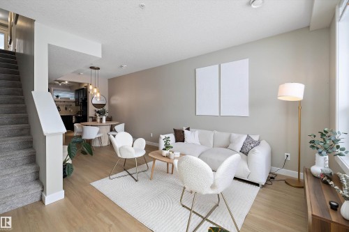 Living area with wood finished floors and a textured ceiling - 94 2560 Pegasus Boulevard, Edmonton, AB - Indoor