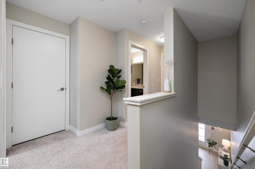 Corridor featuring light carpet and an upstairs landing - 94 2560 Pegasus Boulevard, Edmonton, AB - Indoor Photo Showing Other Room