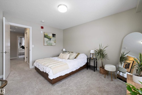 Bedroom featuring light colored carpet and a textured ceiling - 94 2560 Pegasus Boulevard, Edmonton, AB - Indoor Photo Showing Bedroom
