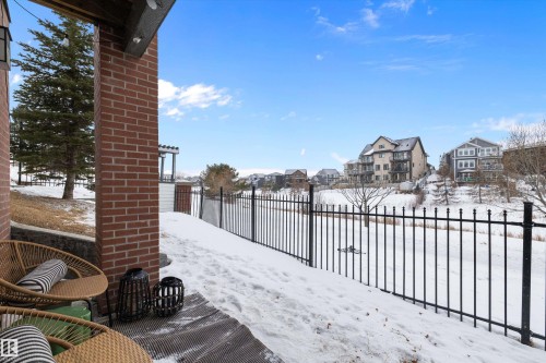 Yard layered in snow featuring a residential view - 94 2560 Pegasus Boulevard, Edmonton, AB - Outdoor