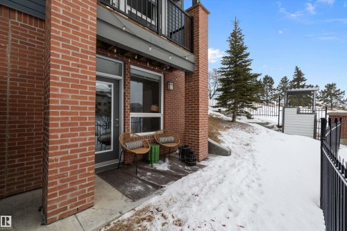 Yard covered in snow featuring a balcony and a patio area - 94 2560 Pegasus Boulevard, Edmonton, AB - Outdoor With Exterior