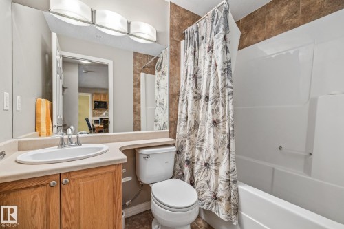 Full bath with vanity and shower / bath combination with curtain - 221 5005 165 Avenue, Edmonton, AB - Indoor Photo Showing Bathroom