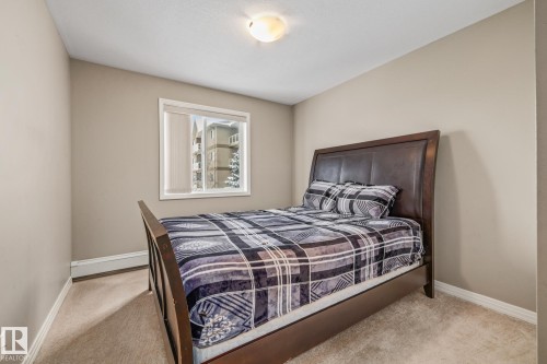 Bedroom featuring baseboards and light carpet - 221 5005 165 Avenue, Edmonton, AB - Indoor Photo Showing Bedroom