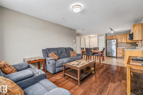 Living room with dark wood-type flooring - 221 5005 165 Avenue, Edmonton, AB - Indoor Photo Showing Living Room