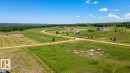 Expansive undeveloped land featuring rolling green hills and a distant tree line - 30 River Ridge Estates, Rural Wetaskiwin County, AB 