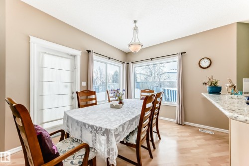 Dining room with baseboards and light wood-style flooring - 4619 151 Avenue Nw, Edmonton, AB - Indoor Photo Showing Dining Room