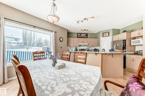 Dining space with light wood-type flooring and a textured ceiling - 4619 151 Avenue Nw, Edmonton, AB - Indoor